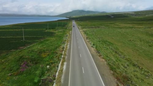 Aerial Road Running Along the Side of a Large Body of Water