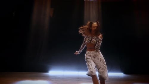 Stylish Woman Dancing in a Studio with Lights