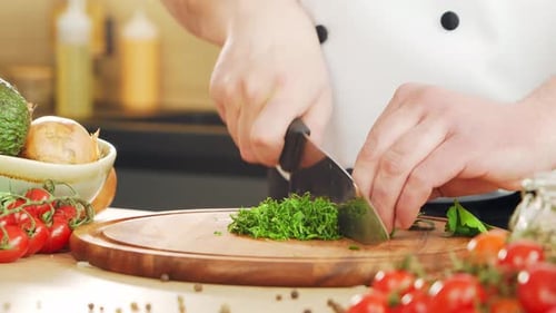 Chef Chopping Fresh Herbs With Sharp Knife