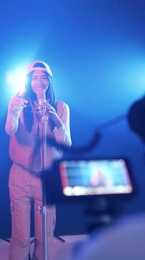 Young Female Singer Recording a Song in a Music Studio Vertical