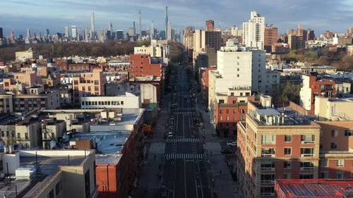 Aerial flight down empty street of Harlem NYC during the Covid-19 pandemic lockdown on a sunny day