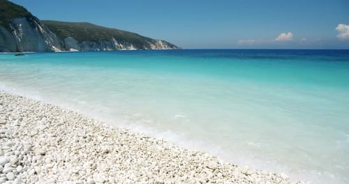 White pebble beach with turquoise blue lagoon on Ionian Island, Greece