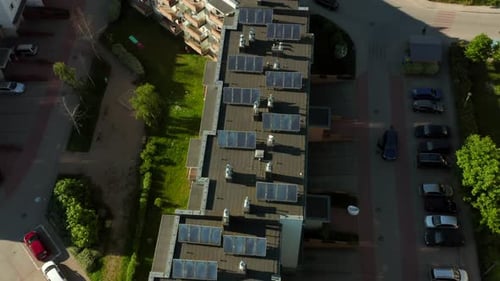 Top View of Apartment Buildings with Solar Panels Photovoltaics on the Roof