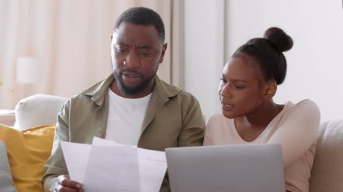 Couple Reviews Documents Together at Home