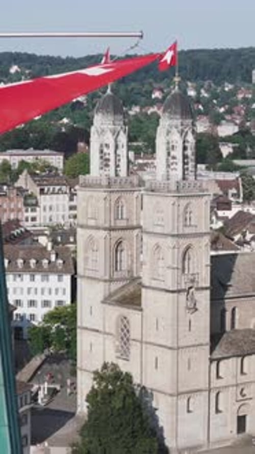 Aerial video of the Swiss flag at the Grossmunster church and the city in the background.
