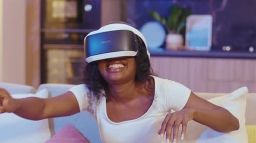 Woman Playing VR Game on Couch at Home