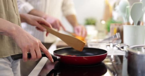 Couple Cooking Fresh Vegetables Together in Bright Kitchen