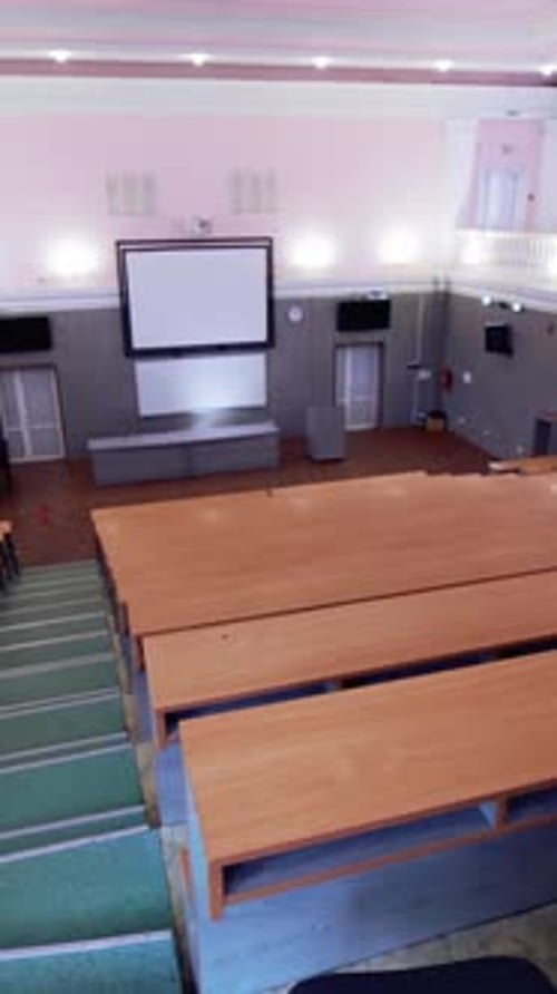 Tables and chairs in classroom. Modern wooden lesson in conference room