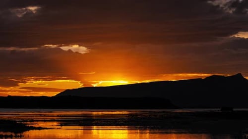 Dramatic Sunrise Over Icelandic Mountains Epic Warm Clouds in Sky Moving in Timelapse Shot in RAW