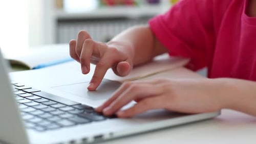 Child Uses Laptop Computer Trackpad and Keyboard
