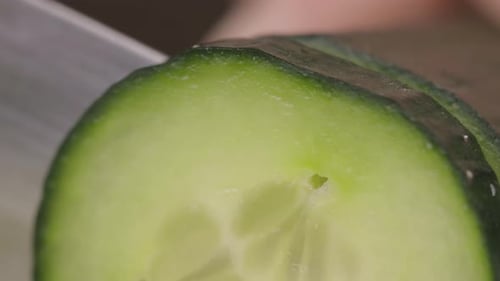 Gros plan d'un concombre tranché à la main. Vidéos de préparation de la cuisine.