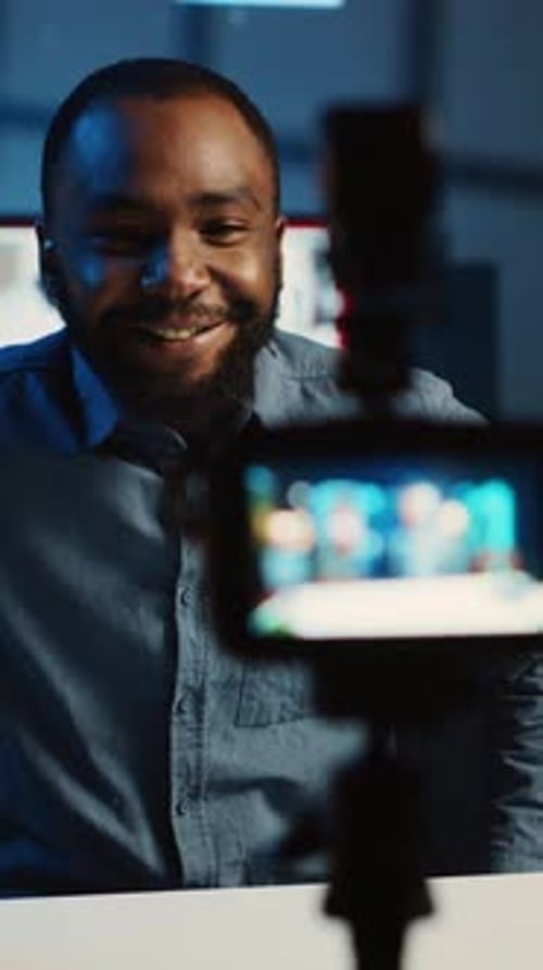 Man Recording Video in Modern Office at Night