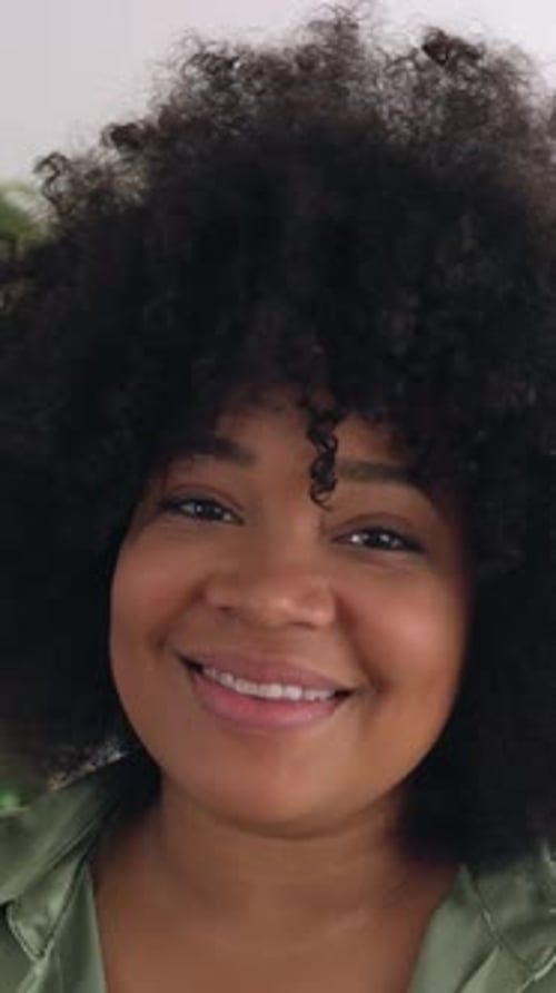 Smiling Portrait of Professional Woman Looking at Camera Standing in an Office
