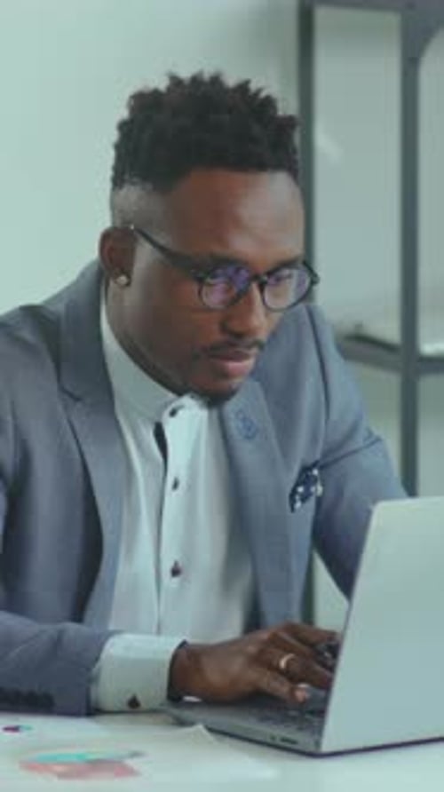 Man Working at Computer in Modern Office Setting