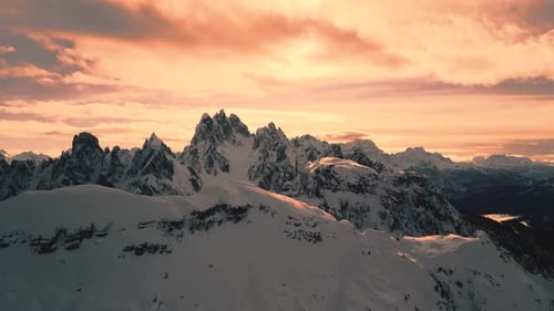 4k Aerial drone footage of snowy mountains at sunset (Dolomites)