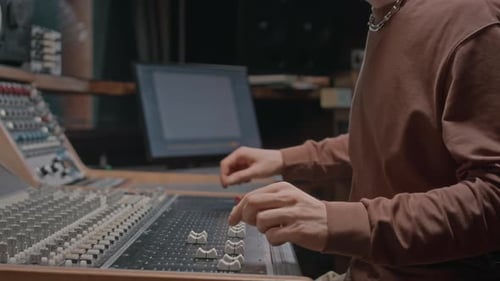 Audio Expert Operating Mixing Board