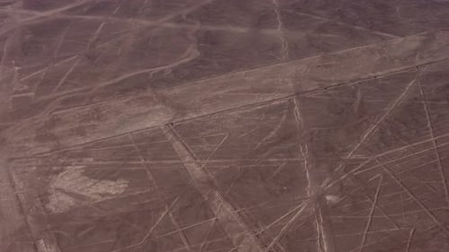 Aerial video of the famous Nazca Lines. Drone flies above many long linear geoglyphs and a depiction
