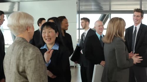 Cheerful diverse business people talking in a busy office building meeting