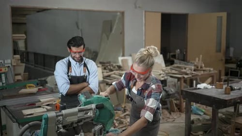 Carpenters are working together at workshop.