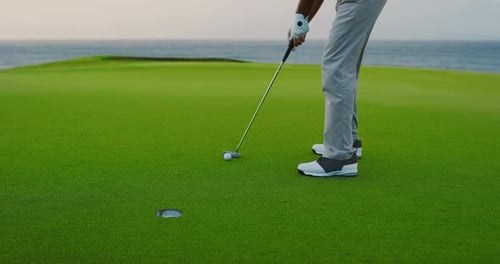 Man Playing Golf by the Ocean at Sunset