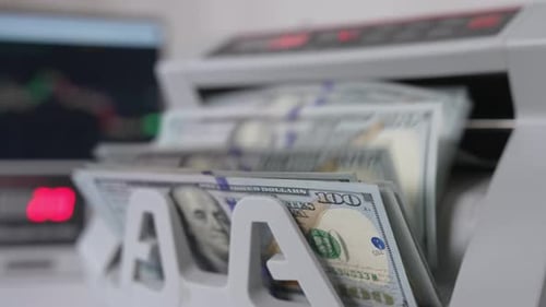 Money Counting Machine Processing Hundred Dollar Bills