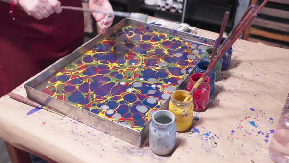 Colorful Paint Marbling Process in Tray of Water, Lifestyle Stock ...