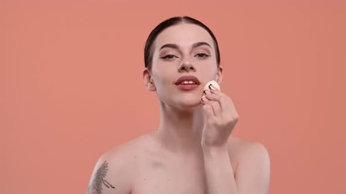 Woman Applying Makeup with Sponge