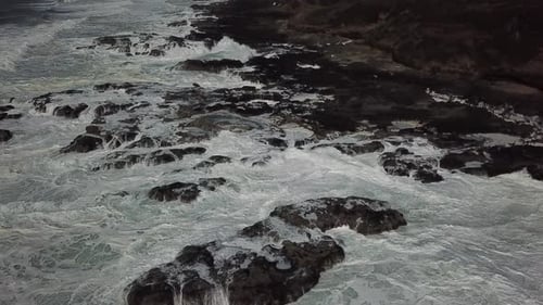 Ocean Waves Crashing on Rocky Coastline from Above