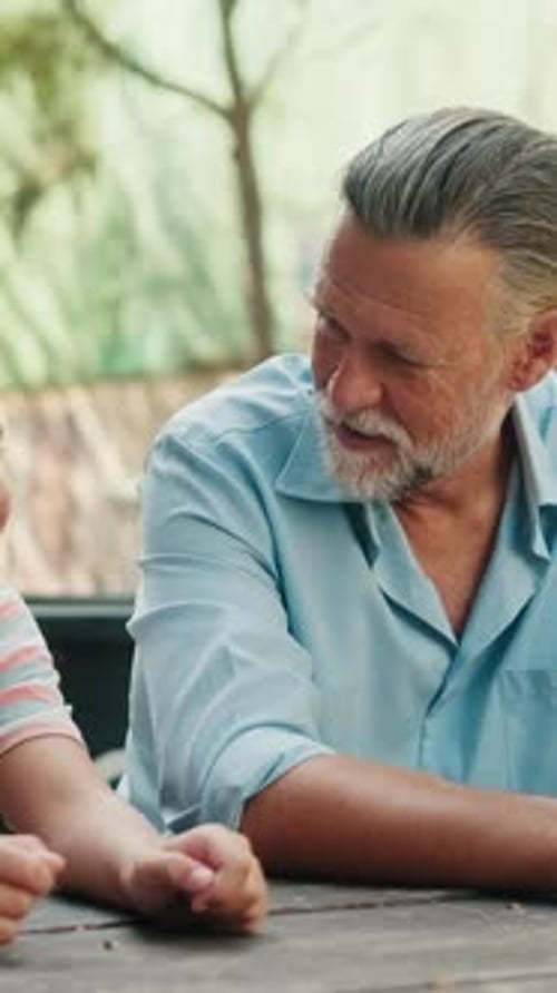 Vertical video, Grandfather and Grandson Having Fun at a Park