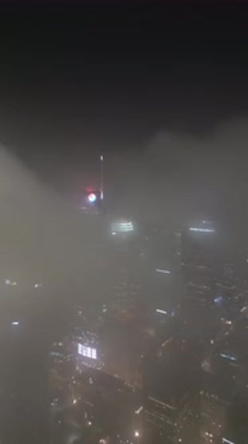 Aerial video of Los Angeles skyline at night in fog, California, USA