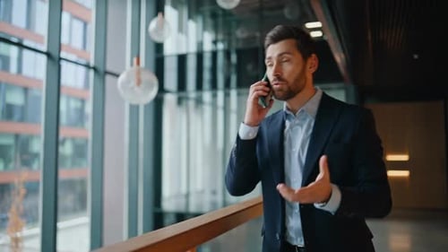 Company Professional Calling Mobile Phone Standing at Office Hall Closeup