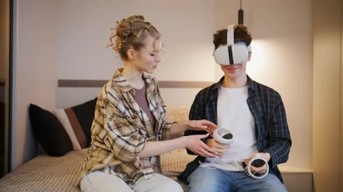Young People Enjoy Virtual Reality Together in a Cozy Room While Using Headsets and Hand Controllers