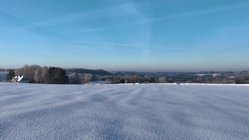 Snowy Field Landscape on a Bright Sunny Winter Day