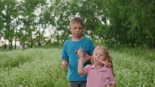Young Siblings Exploring and Laughing in Lush Flower Field Joyful Children and Family Members