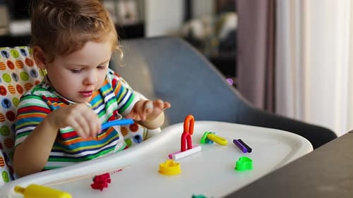 Little Girl Playing with Colorful Modeling Clay