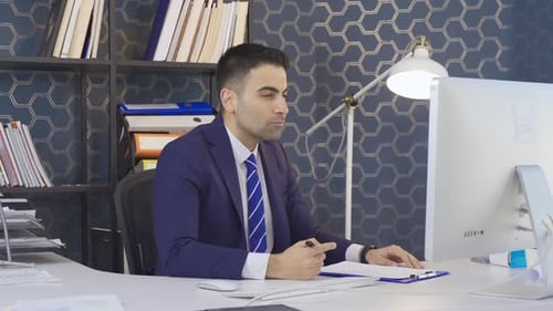 Office worker young man working. Employee talking to customer.