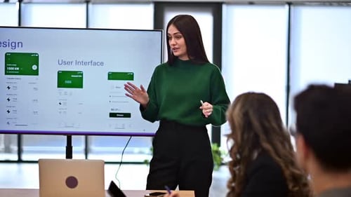 Female worker leading business meeting in an office, discussing business affairs with other workers