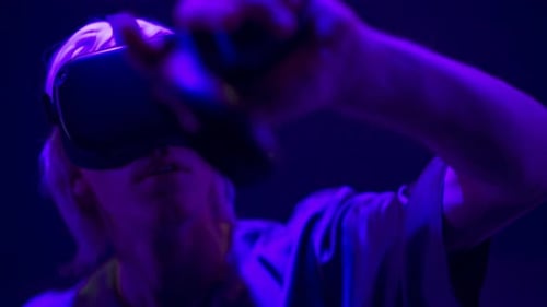 Woman Using Virtual Reality Headset in Neon Lighting