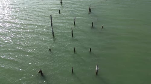 Aerial look down broken fisherman pier