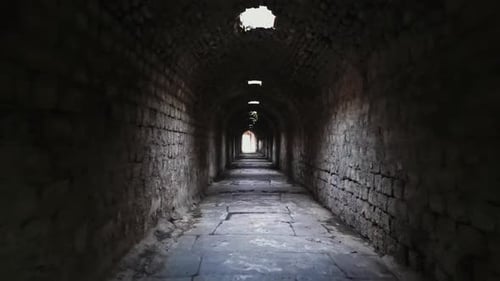Ancient Stone Corridor of Asklepion with Lighted Exit in Bergama