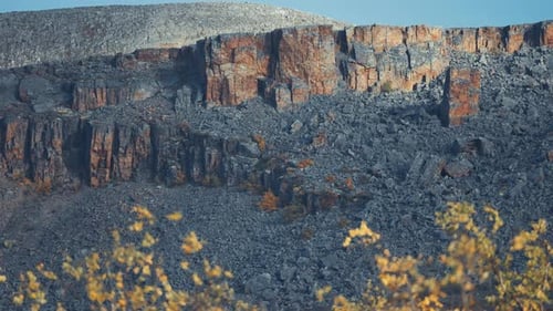 Old withered crumbling rocks in the autumn landscape.