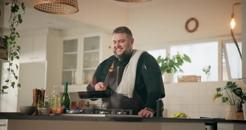 Man Cooking Food in Kitchen at Home