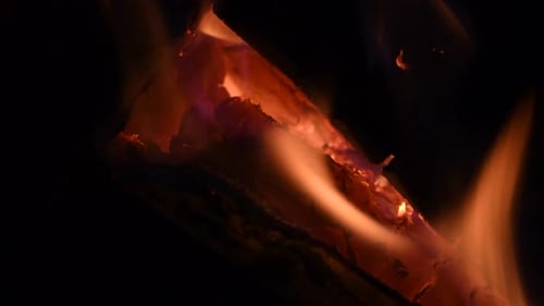 logs burning red hot in a fireplace 3