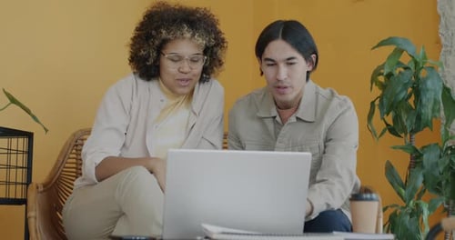 Man and Woman Coworkers Making Online Video Call with Laptop Discussing Business in Creative Office
