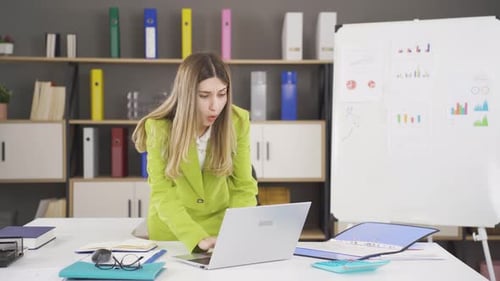 Frustrated Woman Reacts to Laptop in Office