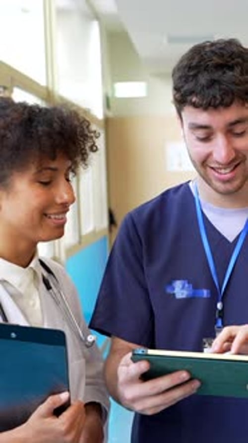 Doctors and Nurses Looking at a Tablet in Hospital
