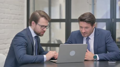 Businessmen Collaborate, Celebrate Success at Workplace