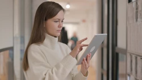 Woman Using Tablet in Modern Bright Office