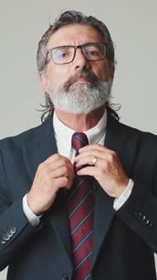 Man in Suit Adjusting Tie