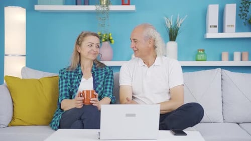 Senior Couple Video Chatting at Home on Laptop